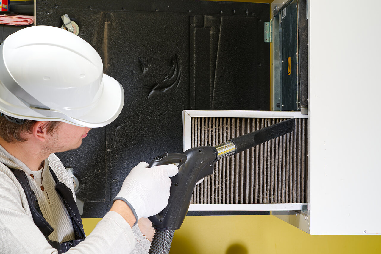 A professional technician replacing a Furnace filter
